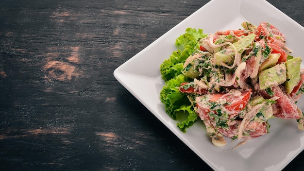 Fresh Vegetable Salad with Walnut Paste Georgian cuisine On the old wooden background Free space for text Top view