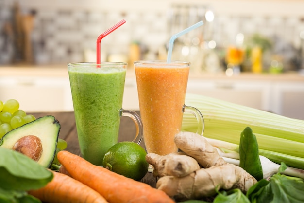 Fresh vegetable smoothies on wooden kitchen table