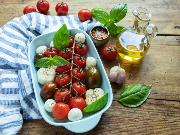 Fresh vegetable tomato basil mozzarella cheese for baking in the oven in ceramic dishes cooking