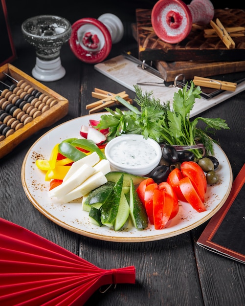 Fresh vegetables appetizer platter with greens