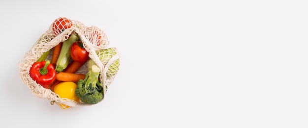 Fresh vegetables in a bag on a white background Top view flat lay Banner