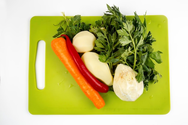 Fresh vegetables; celery, potatoes, carrot in kitchen