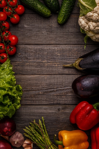 Fresh vegetables for cooking on dark wooden.