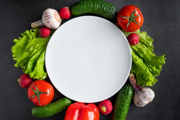 Fresh vegetables on a dark background. The concept of healthy nutrition and diet.