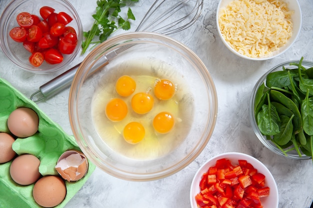 Fresh vegetables and eggs in bowls