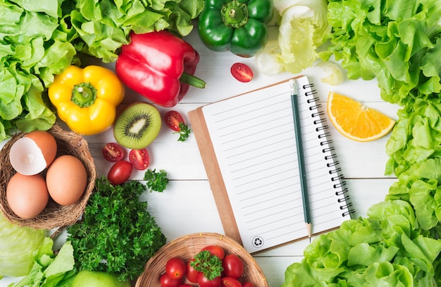 Fresh vegetables and fruit on wood background, healthy food