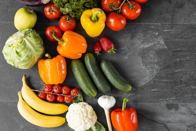 Fresh vegetables and fruits on a black background Organic food Top view Free copy space