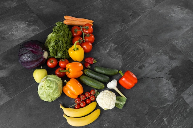 Fresh vegetables and fruits on a black background Organic food Top view Free copy space