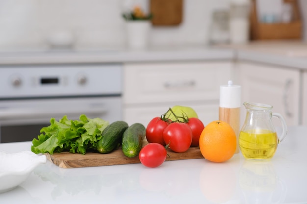 Photo fresh vegetables and fruits on kitchen table modern kitchen interior