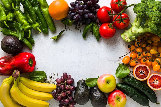 Fresh vegetables and fruits on a white kitchen table.