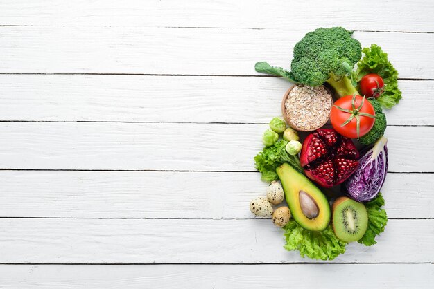 Fresh vegetables and fruits on a white wooden background Healthy Organic Food Top view Free copy space