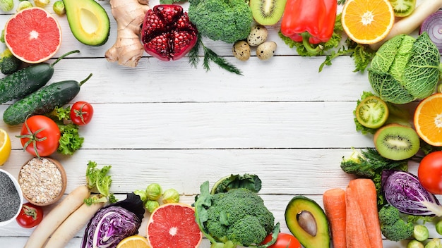 Fresh vegetables and fruits on a white wooden background. Healthy Organic Food. Top view. Free copy space.