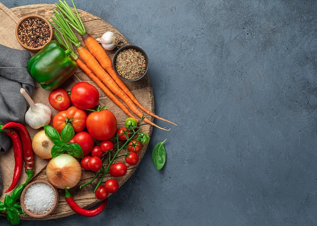 Fresh vegetables, ingredients for cooking a vegetable dish: sauce, salad. Top view, copy space.