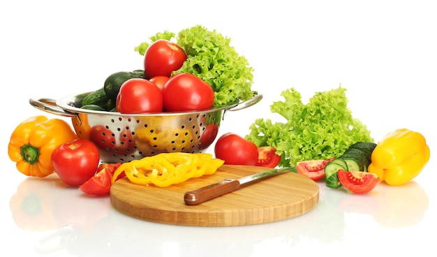 Fresh vegetables and knife on cutting board isolated on white