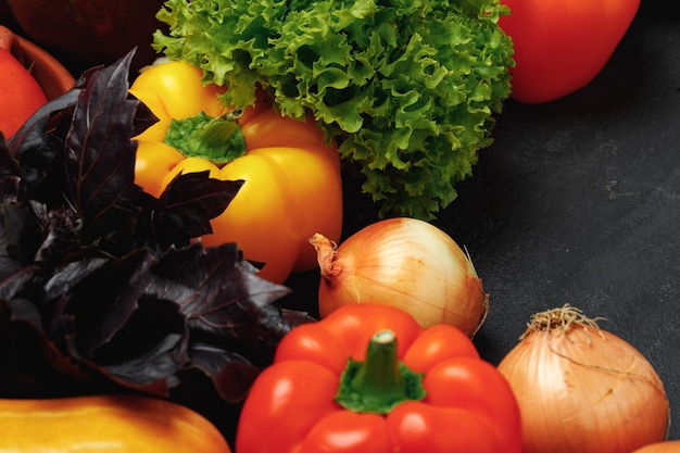 Fresh vegetables pile with salad and basil close up