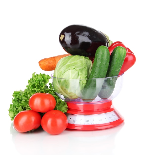 Fresh vegetables in scales isolated on white