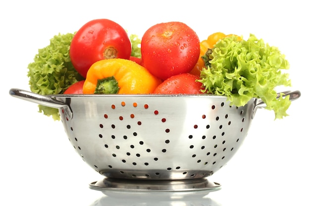 Fresh vegetables in silver colander isolated on white