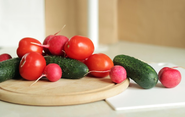 Fresh vegetables on the table side view Tomatoes cucumbers and radishes Vegetables for salad