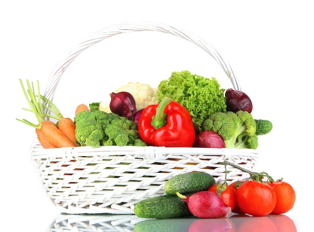 Fresh vegetables in white wicker basket on grey background