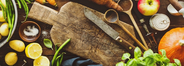 Fresh vegetables with board on wooden table