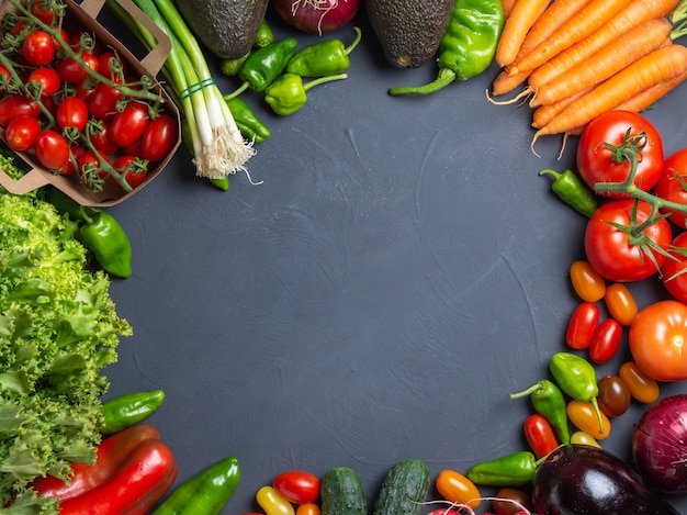 Fresh vegetables with circle in the center for copyspace dark wooden 