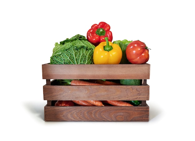 Photo fresh vegetables in a wooden box isolated from white background