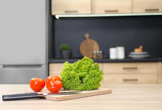 Fresh vegetables on wooden table in kitchen space for text