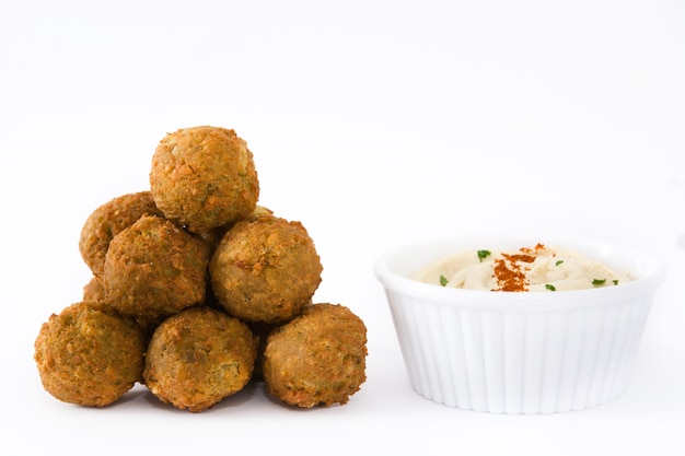 Fresh vegetarian falafels and hummus isolated on white surface