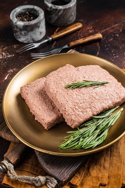 Fresh Veggie mince meat raw plant based meat with rosemary Dark background Top view