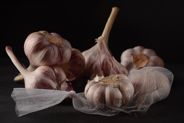 Fresh violet garlic bulbs  on a black background