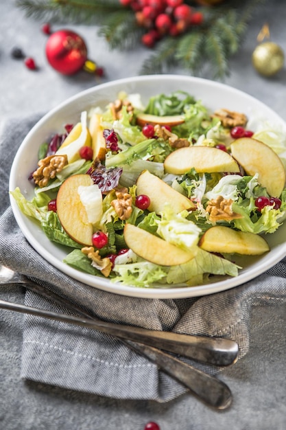 Fresh Waldorf salad with lettuce, green apples, walnuts and celery on wooden table. Top view.Copy space