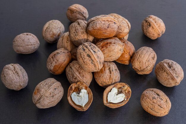 Fresh walnuts on black background.