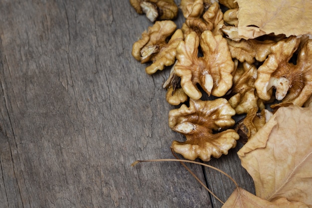 Fresh walnuts kernels on dark wooden.