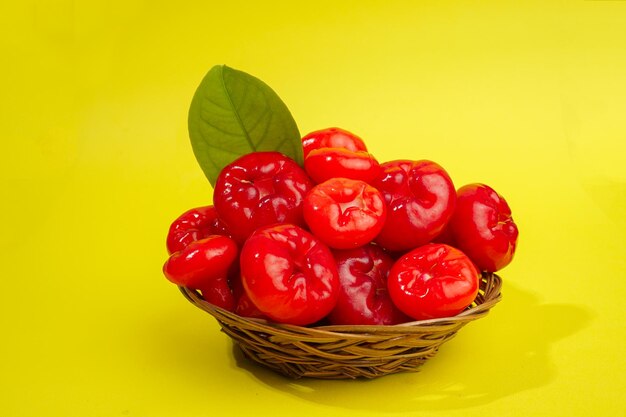 Fresh water apple fruit and some water apple on basket behind on yellow background