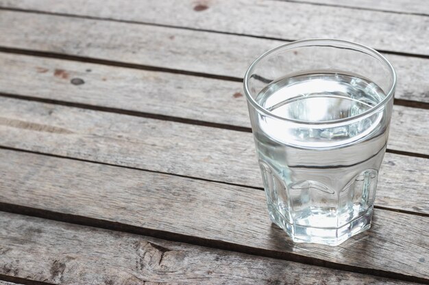 Fresh water in the glass on wooden table