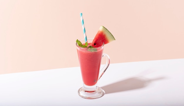 Fresh water melon juice and watermelon slice on color background. summer drink.