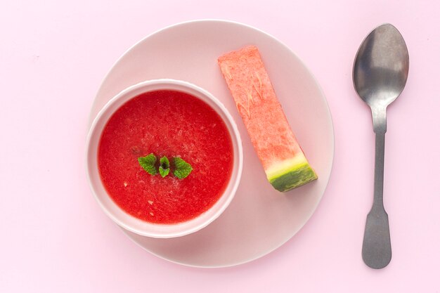 Fresh watermelon mint juice on pink background from above