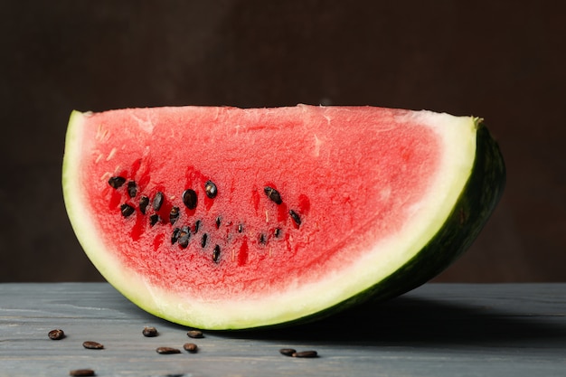 Fresh watermelon slice on gray wooden table. Summer fruit