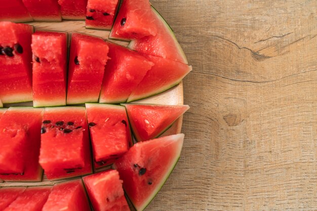 fresh watermelon sliced on wooden plate