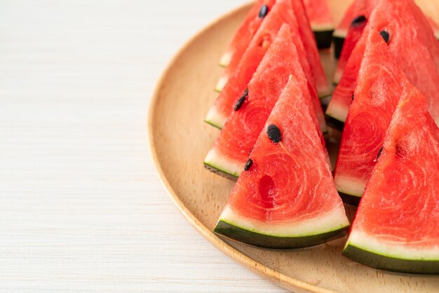 fresh watermelon sliced on wooden plate