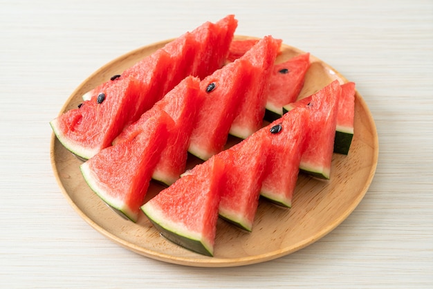 fresh watermelon sliced on wooden plate