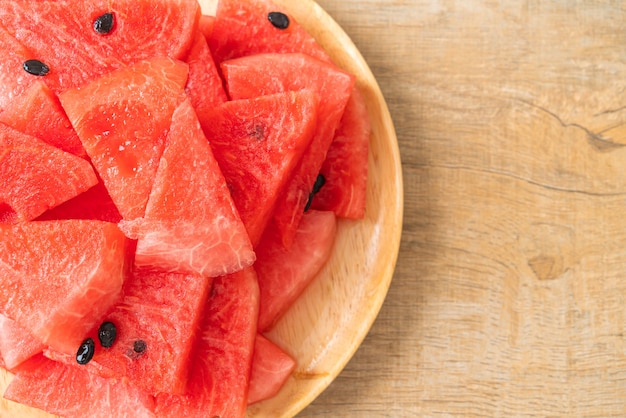 fresh watermelon sliced on wooden plate