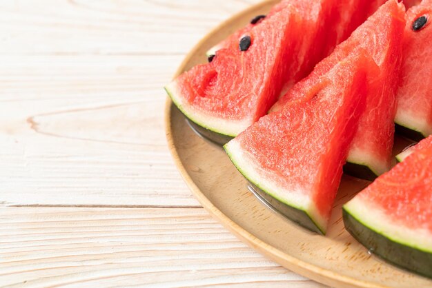 fresh watermelon sliced on wooden plate