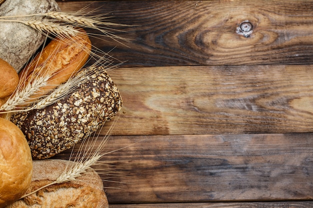 Fresh white and black bread on a wooden table