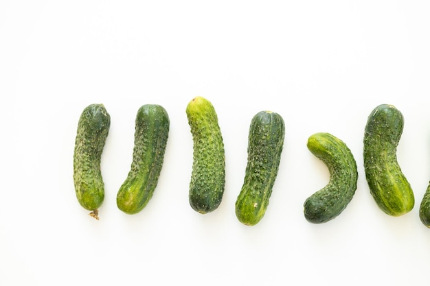 Fresh whole ripe cucumbers as background closeup