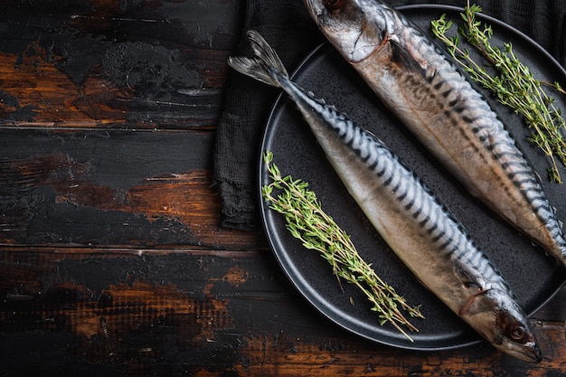 Fresh whole seafish with ingredients on wooden table