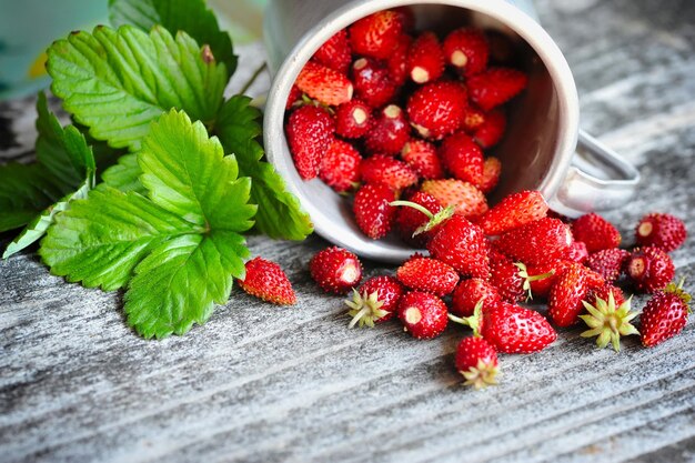 Fresh wild strawberries on an old wooden table