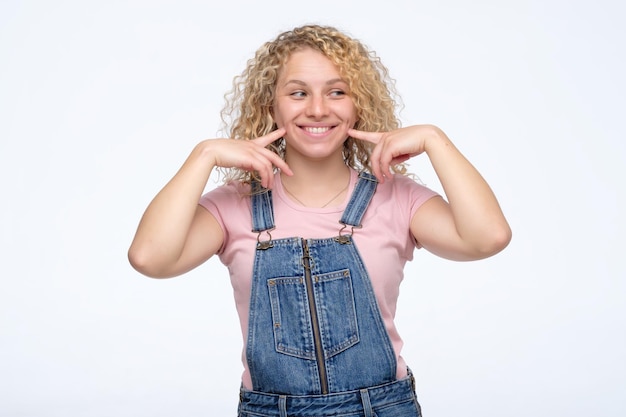 Fresh woman with blonde curly shows us her happy smile