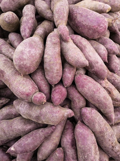 Photo fresh yams for sale on the market. soft focus.