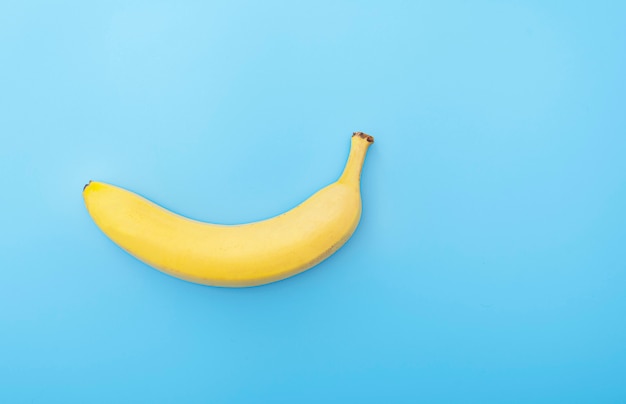 fresh yellow banana on blue surface